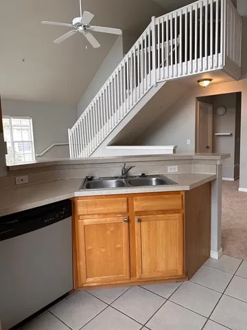 a kitchen with granite countertop a sink a stove and cabinets