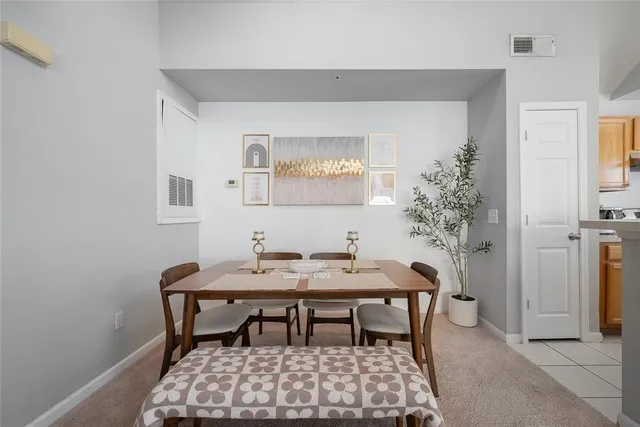a dining room with a table and chairs