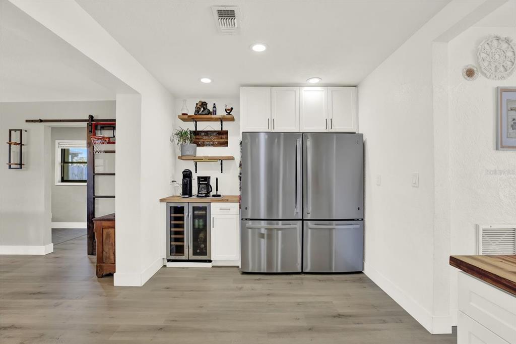 6060 39th Avenue North St. Petersburg, FL 33709 - Photo 11 of 29 a view of a kitchen with refrigerator and wooden floor