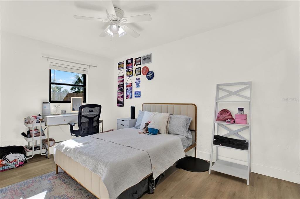 6060 39th Avenue North St. Petersburg, FL 33709 - Photo 19 of 29 a bedroom with a bed and a chandelier