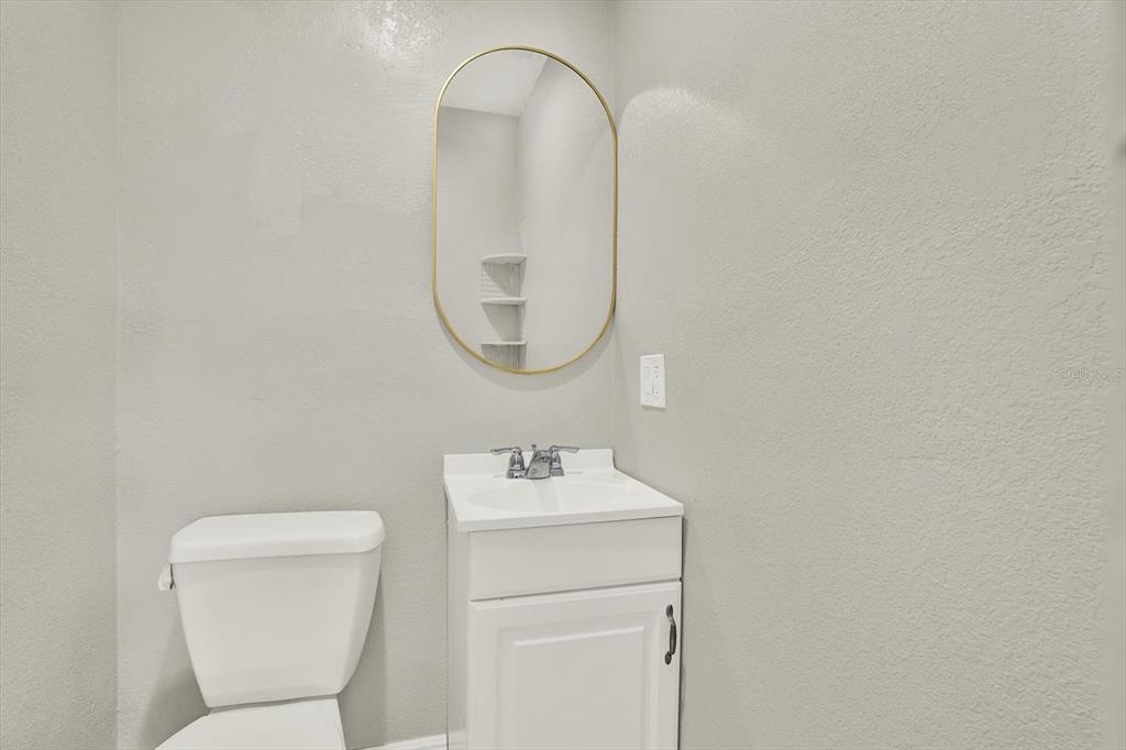 6060 39th Avenue North St. Petersburg, FL 33709 - Photo 20 of 29 a bathroom with a toilet sink and mirror