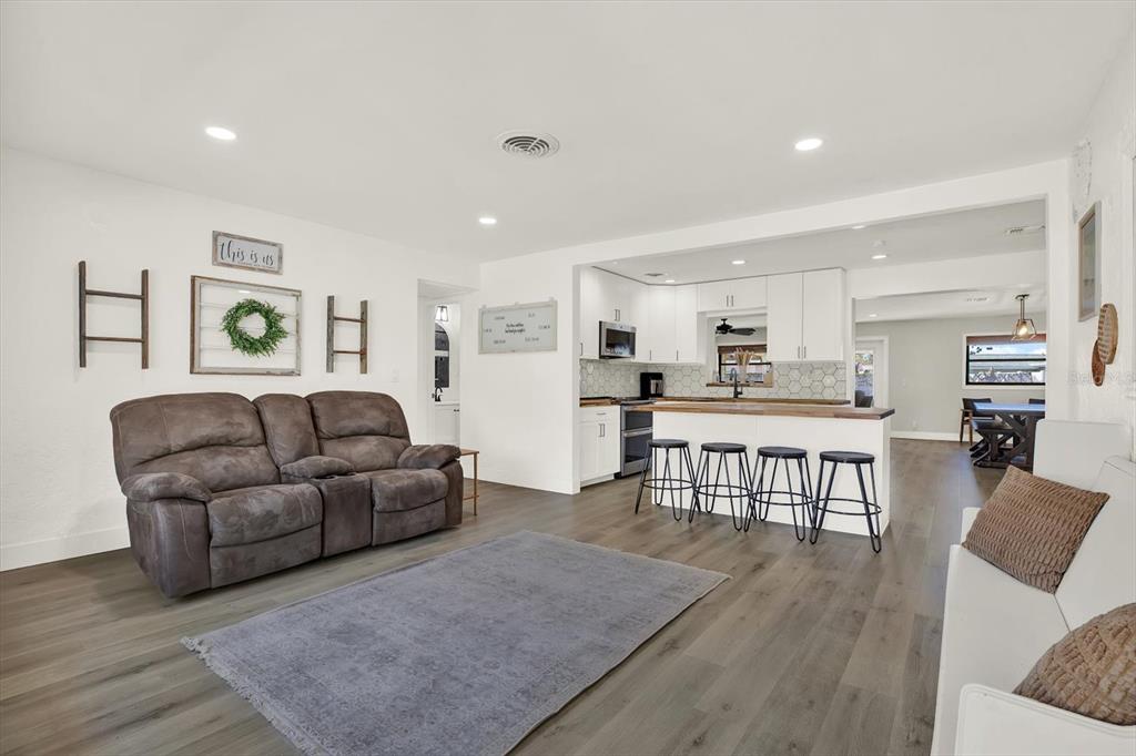 6060 39th Avenue North St. Petersburg, FL 33709 - Photo 3 of 29 a living room with furniture and kitchen view