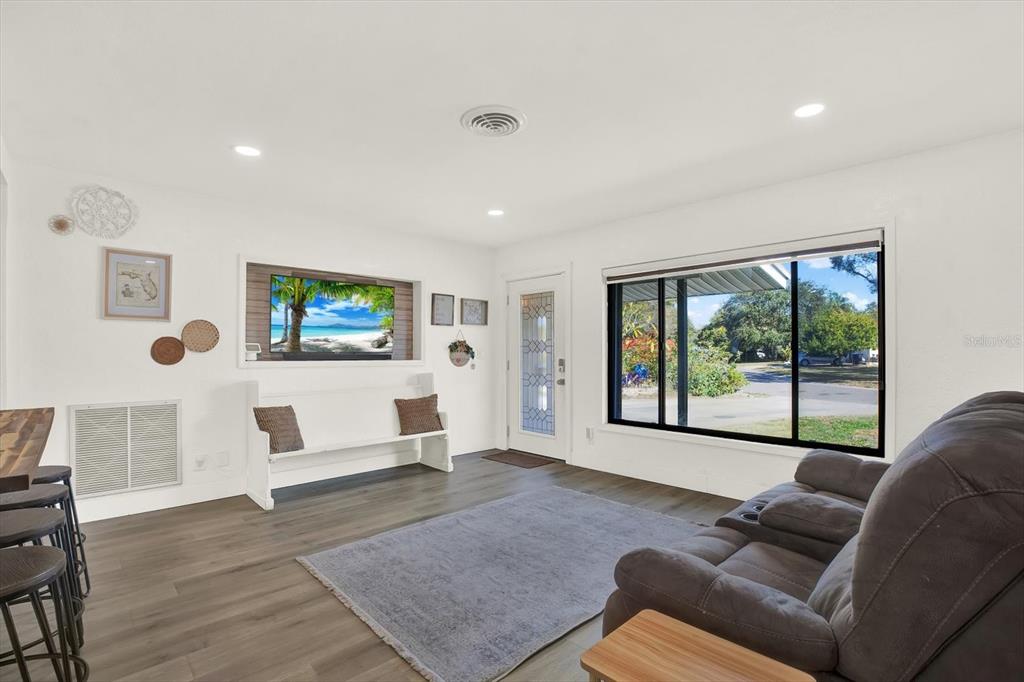 6060 39th Avenue North St. Petersburg, FL 33709 - Photo 5 of 29 a living room with furniture and a flat screen tv
