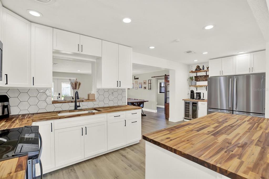 6060 39th Avenue North St. Petersburg, FL 33709 - Photo 10 of 29 a large kitchen with kitchen island a sink stainless steel appliances and cabinets
