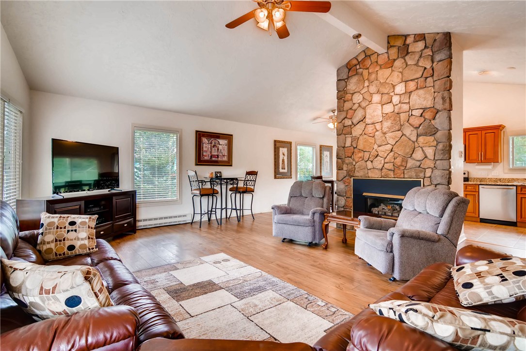 738 Deer Path Road Dillon, CO 80435 - Photo 4 of 25 Bright spacious great room with gas fireplace, vaulted ceiling, and laminate "wood" flooring.