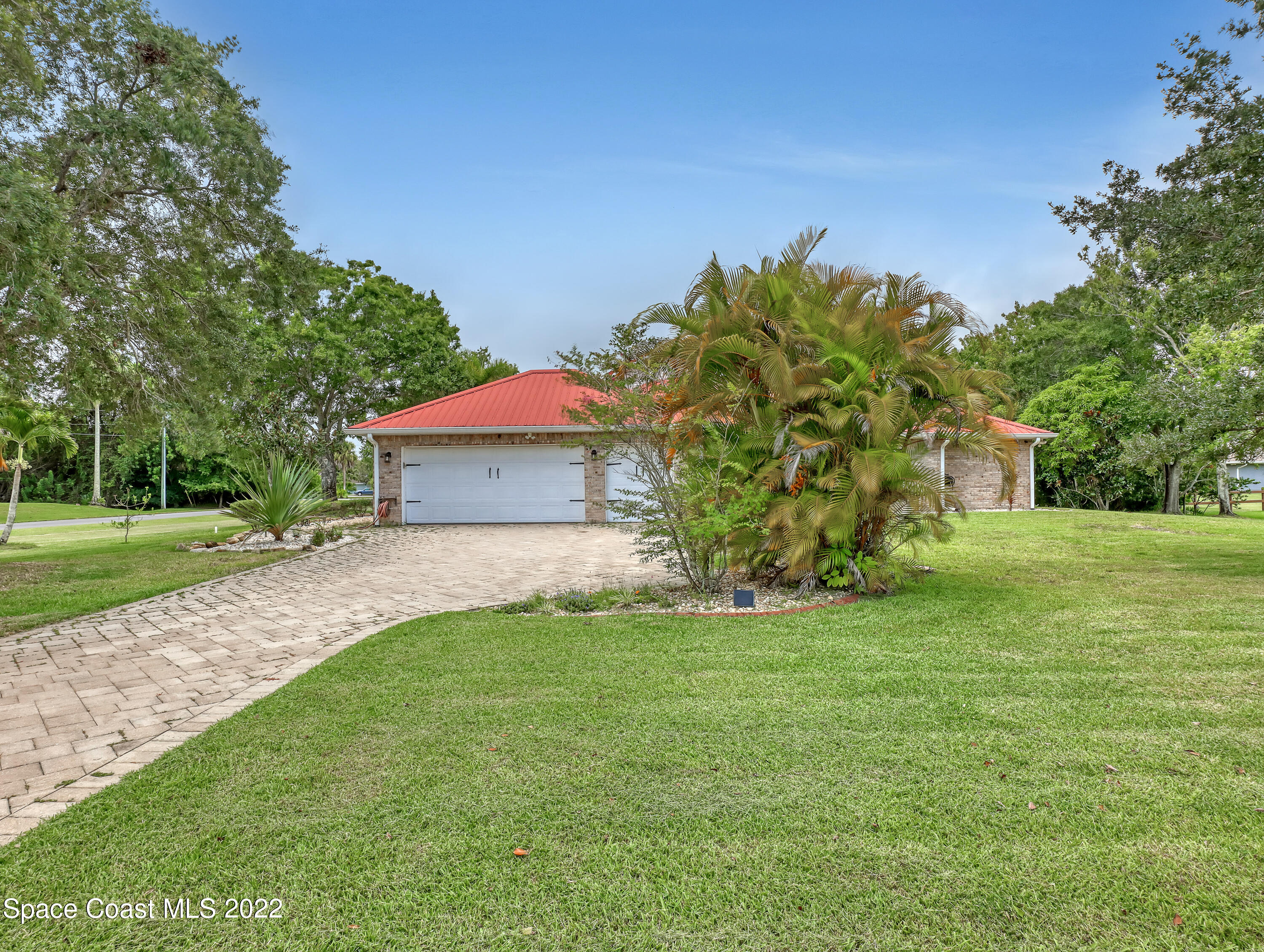 4304 Long Lake Road Melbourne, FL 32934 - Photo 38 of 40 a front view of a house with a yard