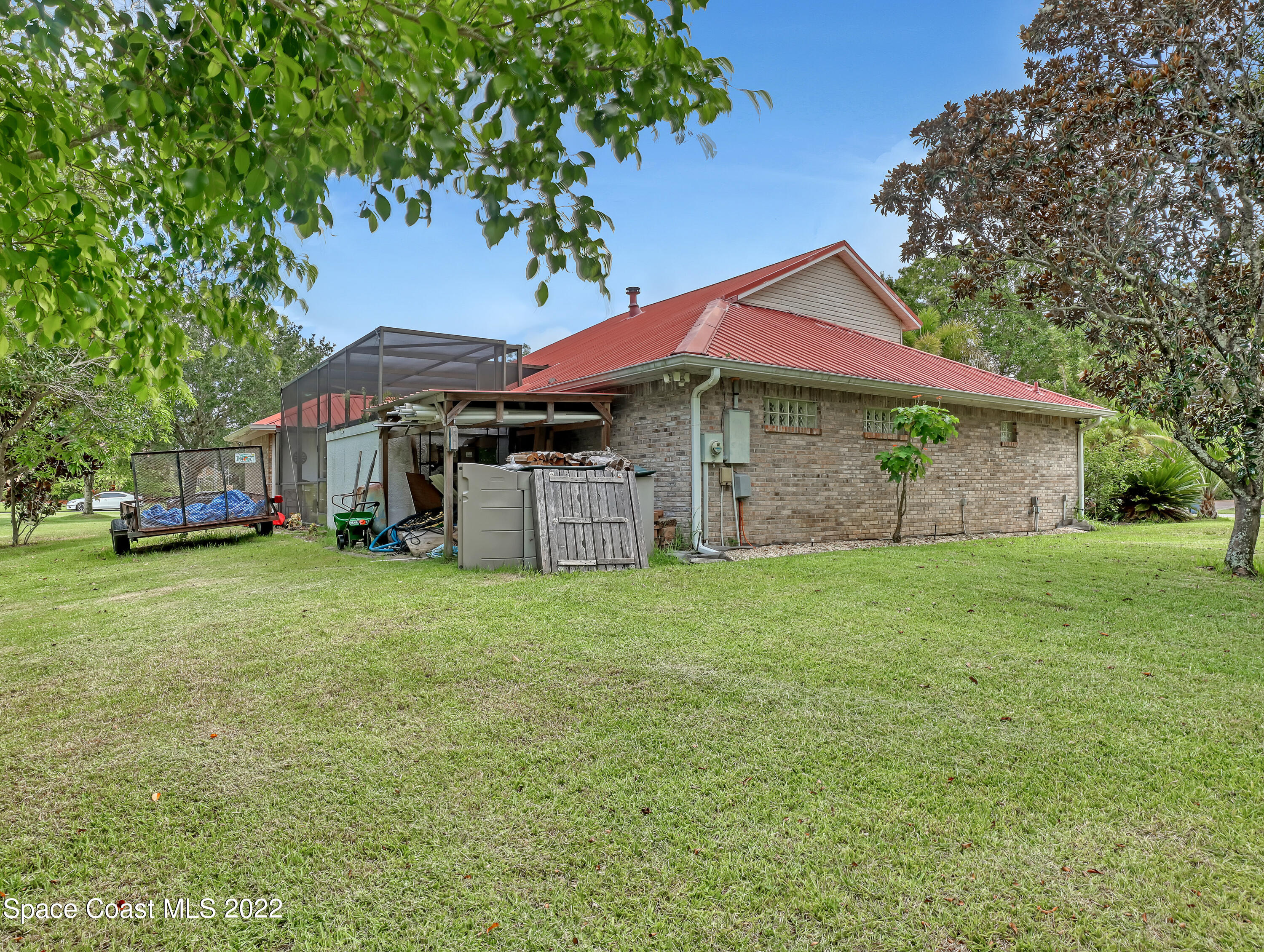 4304 Long Lake Road Melbourne, FL 32934 - Photo 39 of 40 a front view of a house with a garden