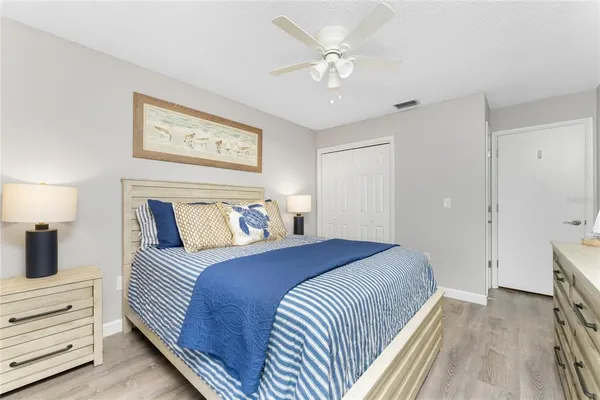 a bedroom with a large bed and a chandelier
