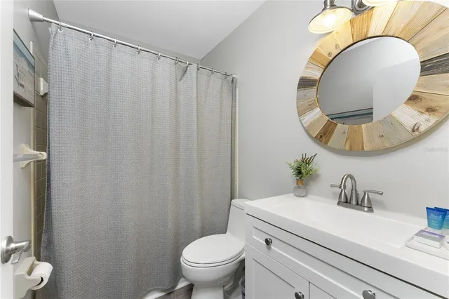 a bathroom with a sink mirror vanity and toilet