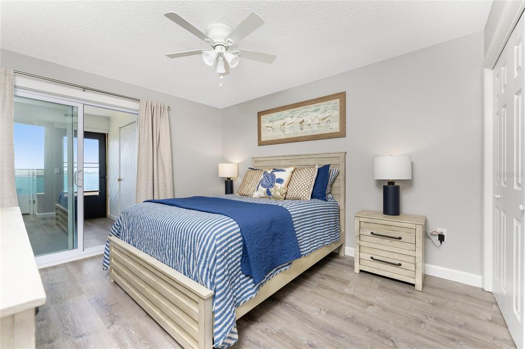 5041 North Beach Road, Unit 4A Englewood, FL 34223 - Photo 10 of 18 a bedroom with a bed and a lamp on table