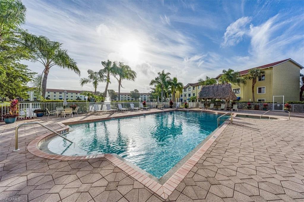 8288 Key Royal Lane, Unit 1424 Naples, FL 34119 - Photo 13 of 13 a view of swimming pool with outdoor seating and plants