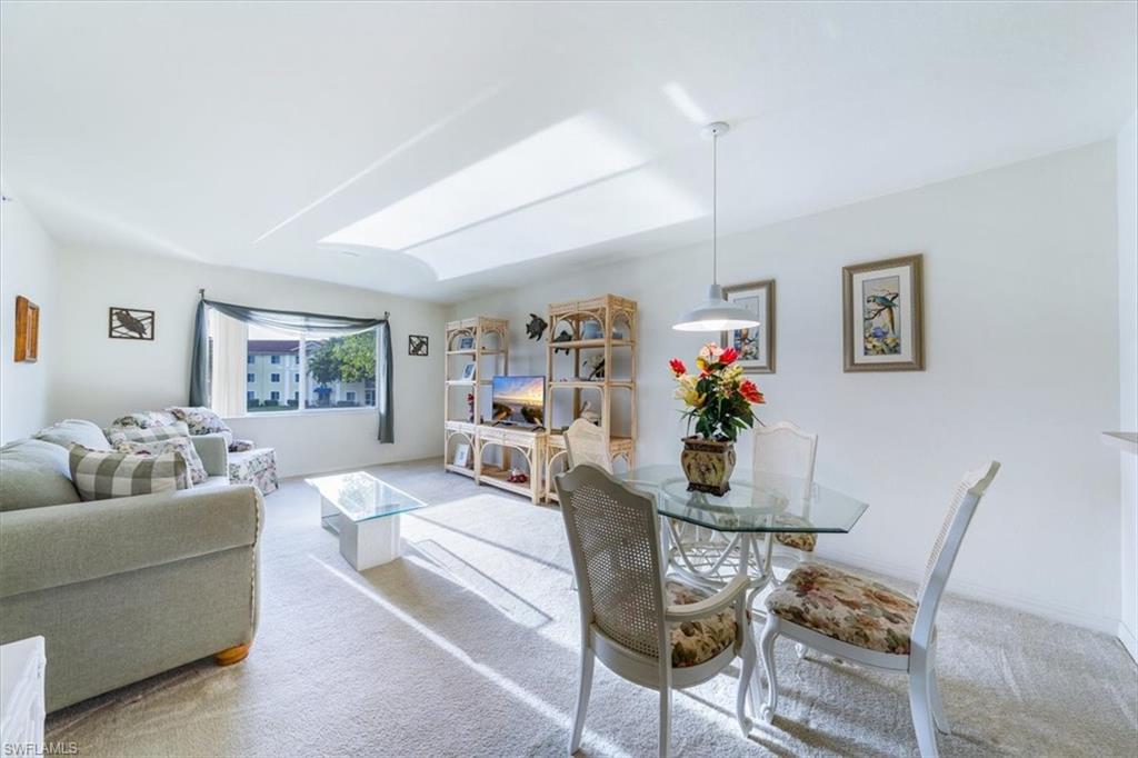 8288 Key Royal Lane, Unit 1424 Naples, FL 34119 - Photo 3 of 13 a living room with furniture and a wooden floor