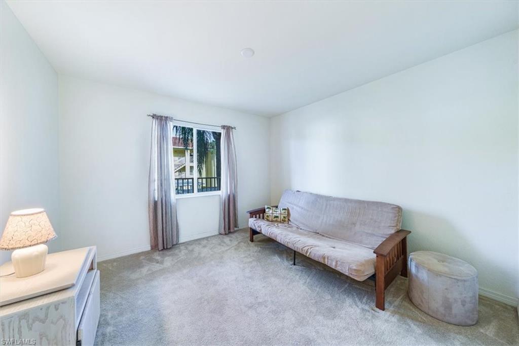 8288 Key Royal Lane, Unit 1424 Naples, FL 34119 - Photo 6 of 13 a living room with furniture and a window