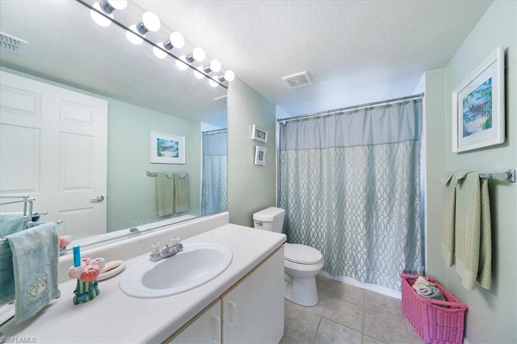 8288 Key Royal Lane, Unit 1424 Naples, FL 34119 - Photo 8 of 13 a bathroom with a sink toilet and shower