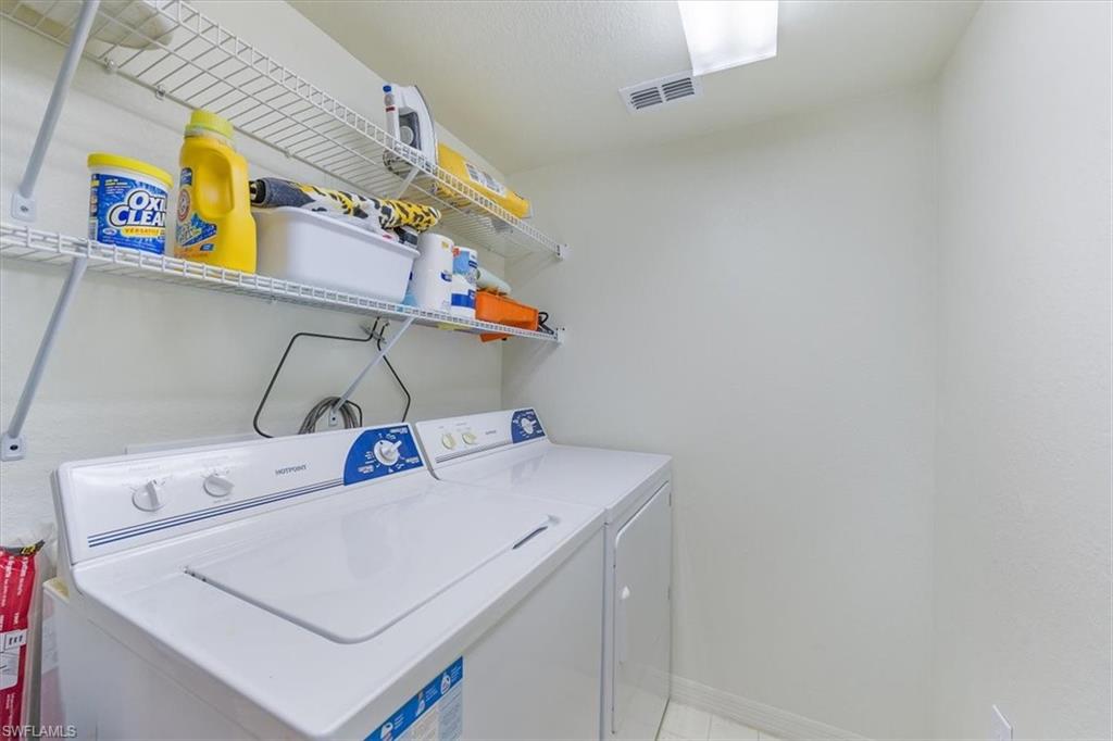 8288 Key Royal Lane, Unit 1424 Naples, FL 34119 - Photo 10 of 13 a utility room with dryer and washer