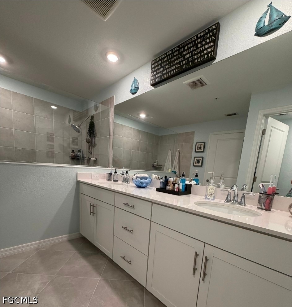 14191 Poppy Fld Loop, Unit 5312 Punta Gorda, FL 33955 - Photo 21 of 41 a bathroom with a double vanity sink and a mirror