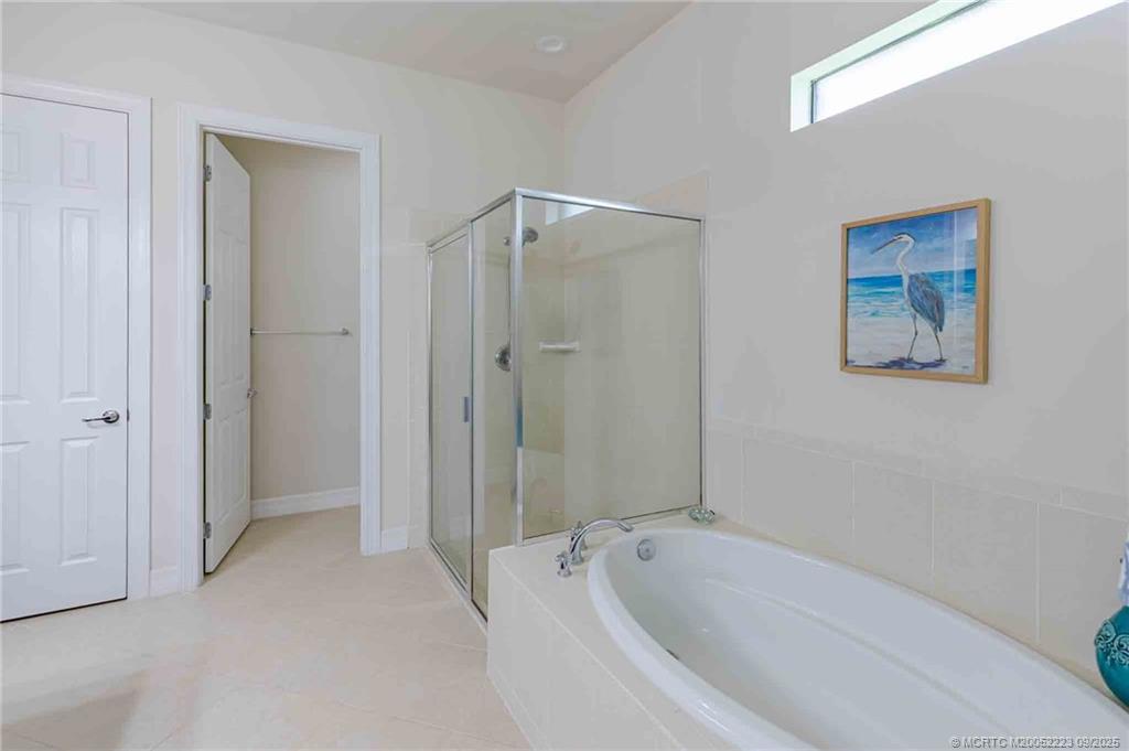1092 Southwest Scrub Oak Avenue Palm City, FL 34990 - Photo 12 of 45 a bathroom with a tub shower and sink