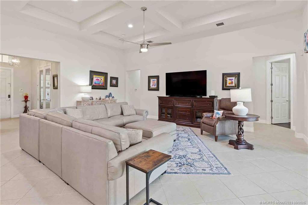 1092 Southwest Scrub Oak Avenue Palm City, FL 34990 - Photo 20 of 45 a living room with furniture and a flat screen tv