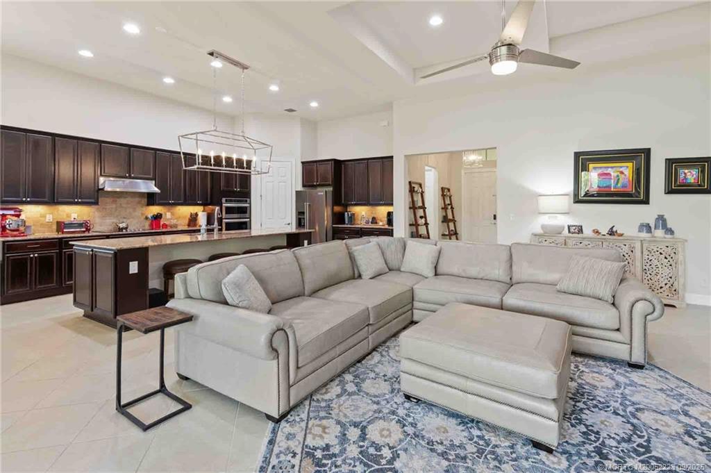 1092 Southwest Scrub Oak Avenue Palm City, FL 34990 - Photo 21 of 45 a living room with furniture kitchen and a flat screen tv