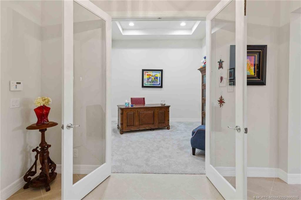 1092 Southwest Scrub Oak Avenue Palm City, FL 34990 - Photo 24 of 45 a view of a hallway with a livingroom and furniture