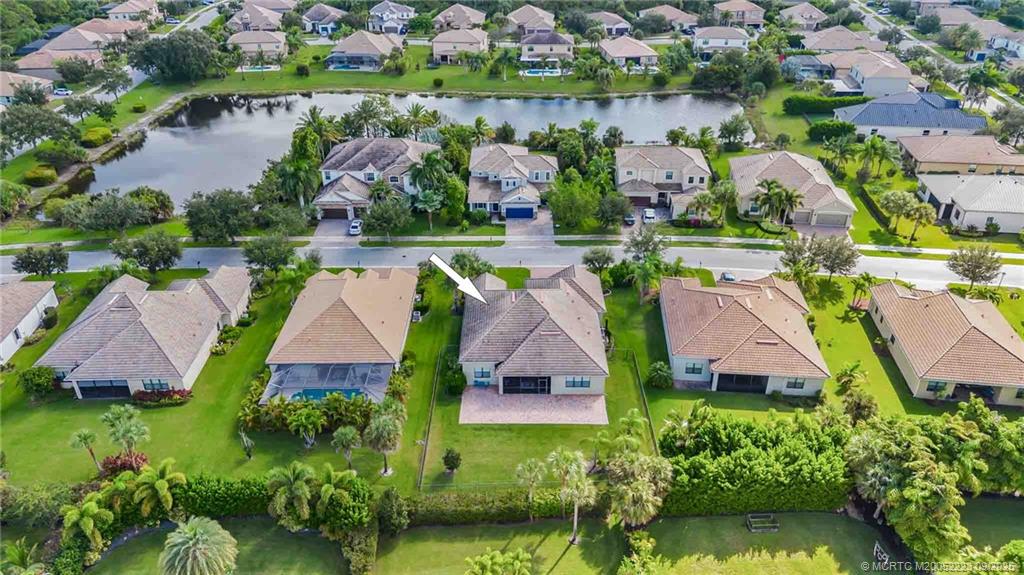 1092 Southwest Scrub Oak Avenue Palm City, FL 34990 - Photo 3 of 45 an aerial view of house with yard swimming pool and outdoor seating