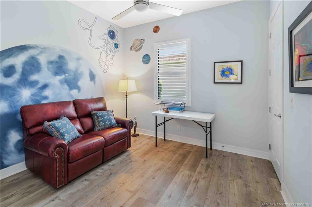 1092 Southwest Scrub Oak Avenue Palm City, FL 34990 - Photo 32 of 45 a living room with furniture and a wooden floor