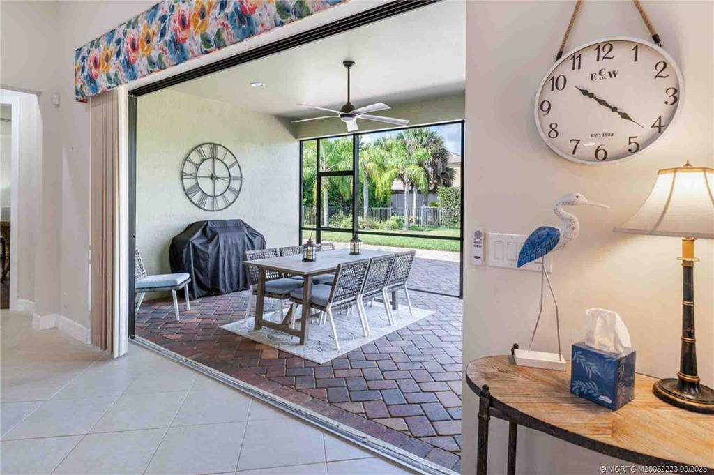 1092 Southwest Scrub Oak Avenue Palm City, FL 34990 - Photo 33 of 45 a dining room with a large window table and chairs