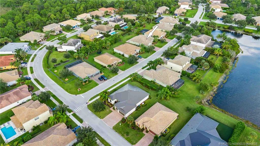 1092 Southwest Scrub Oak Avenue Palm City, FL 34990 - Photo 5 of 45 an aerial view of a house with a yard and outdoor seating
