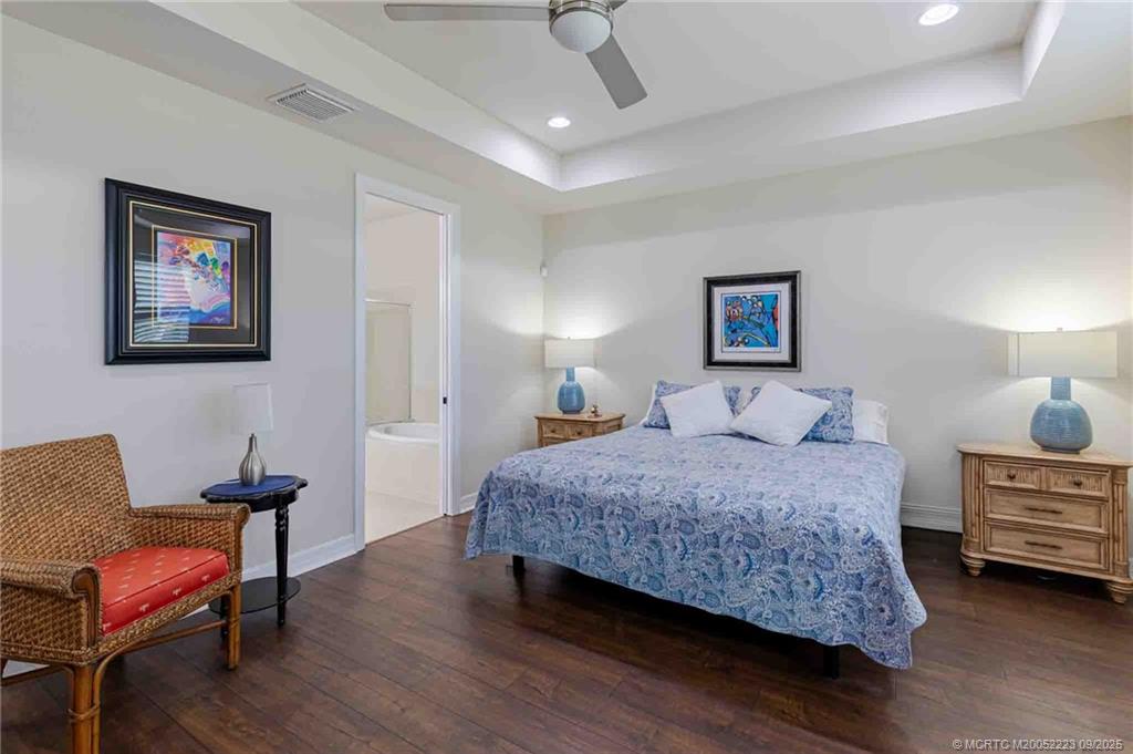 1092 Southwest Scrub Oak Avenue Palm City, FL 34990 - Photo 10 of 45 a bedroom with a bed and a chair