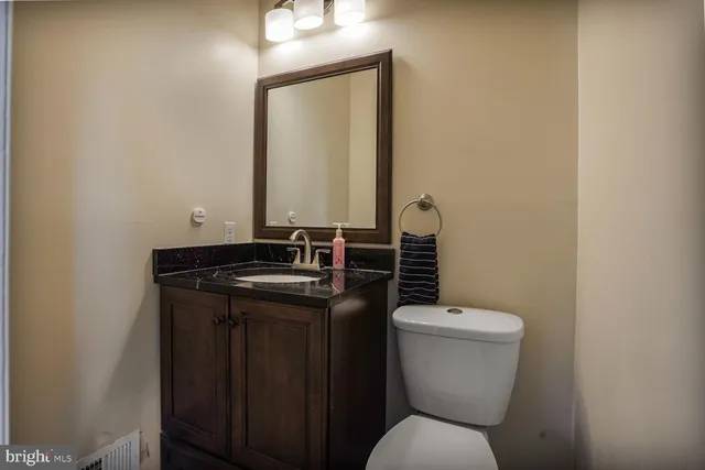 a bathroom with a toilet a sink and mirror