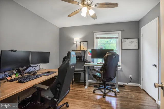 a view of a workspace with furniture and a window