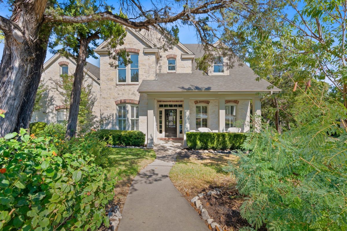 8701 Bluegrass Drive Austin, TX 78759 - Photo 1 of 1 a front view of a house with a yard and potted plants