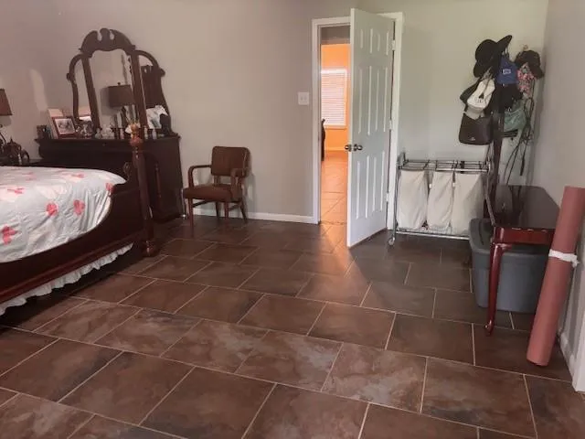 a bedroom with double bed and a dresser