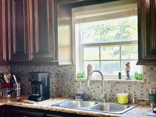 a kitchen with a sink and a window