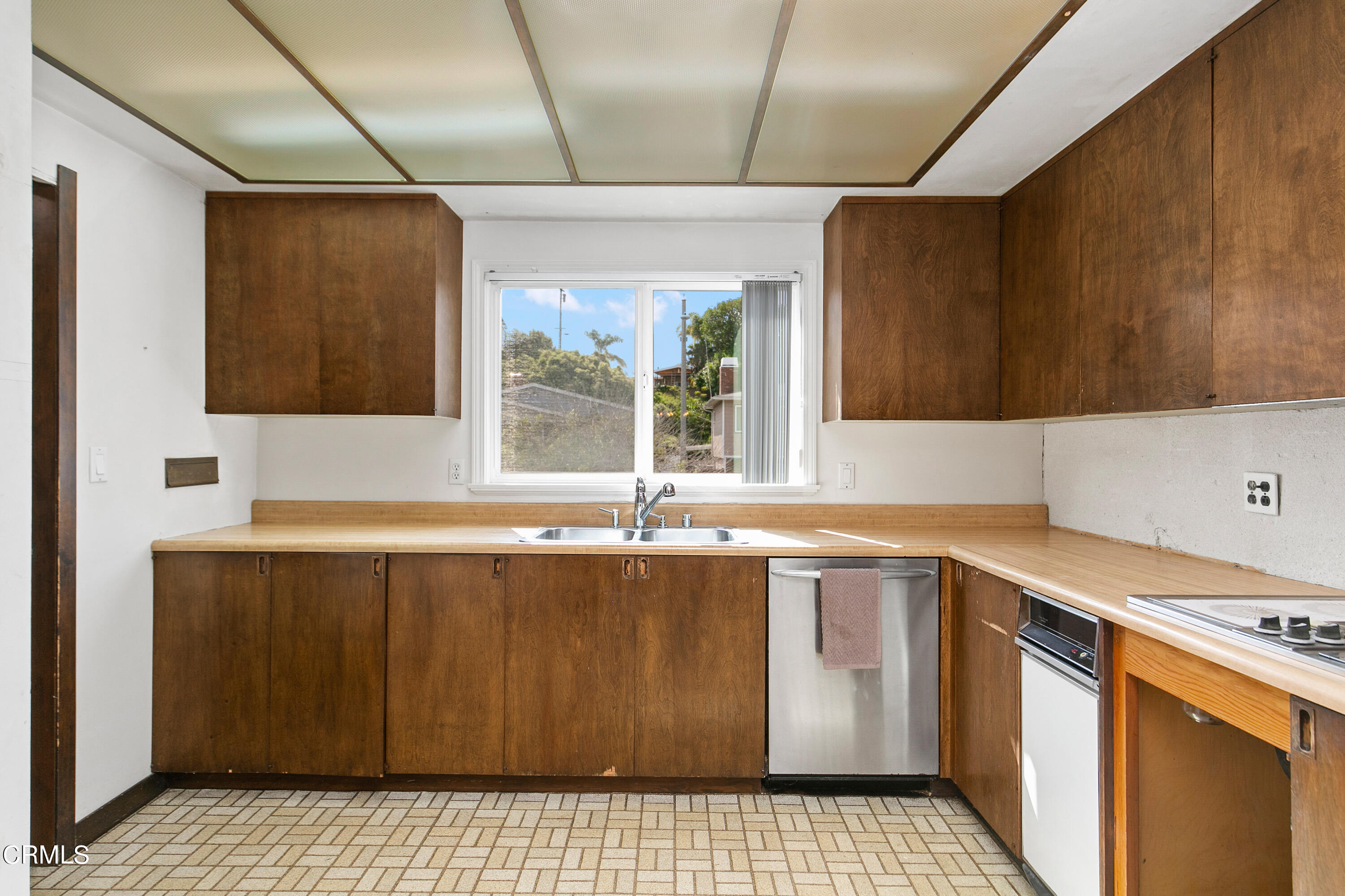 4721 Reese Road Torrance, CA 90505 - Photo 15 of 32 a kitchen with a sink a stove cabinets and wooden floor