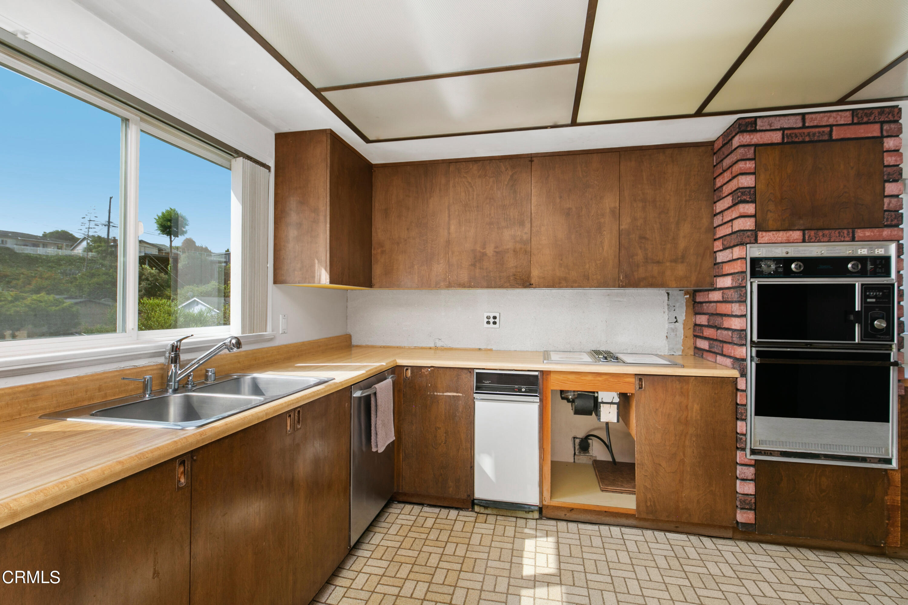 4721 Reese Road Torrance, CA 90505 - Photo 17 of 32 a kitchen with a sink and a refrigerator