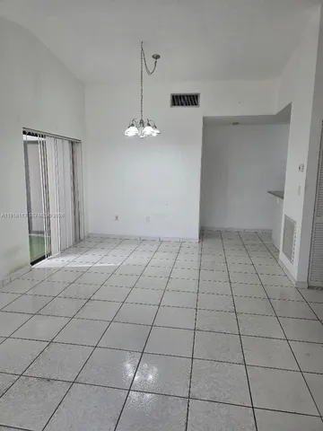 a kitchen with granite countertop a refrigerator and a stove top oven
