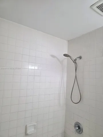 a bathroom with a toilet and a bath tub