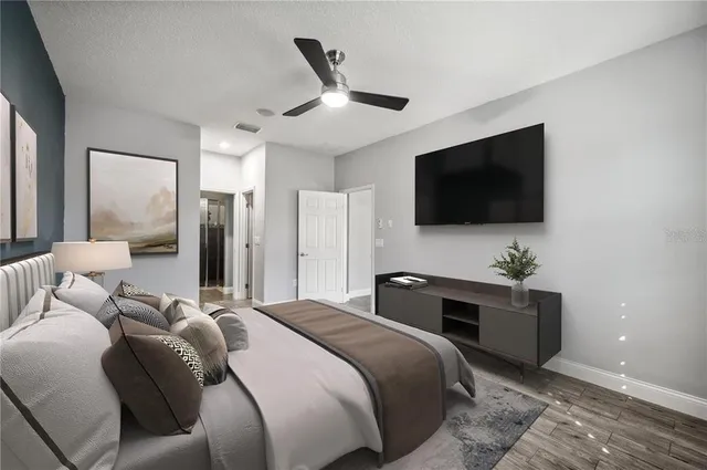 a bedroom with a bed and a flat screen tv