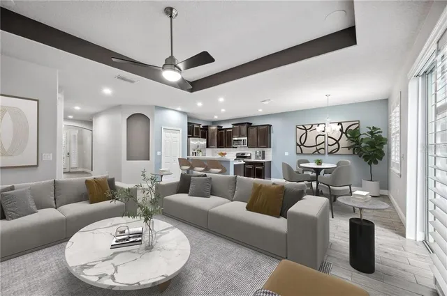 a living room with furniture kitchen and a chandelier