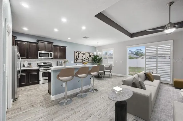 a living room with furniture a window and kitchen view