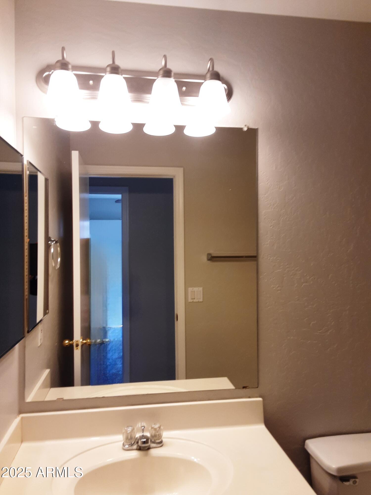 1401 East Jasper Drive Gilbert, AZ 85296 - Photo 20 of 51 a bathroom with a sink and a mirror