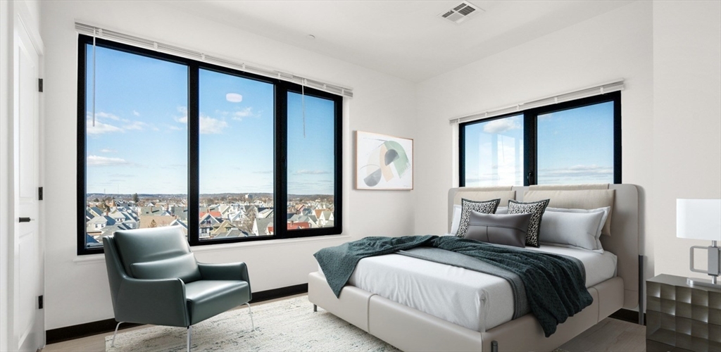 600 Broadway, Unit 614 Chelsea, MA 02150 - Photo 4 of 25 a bedroom with a bed and a large window