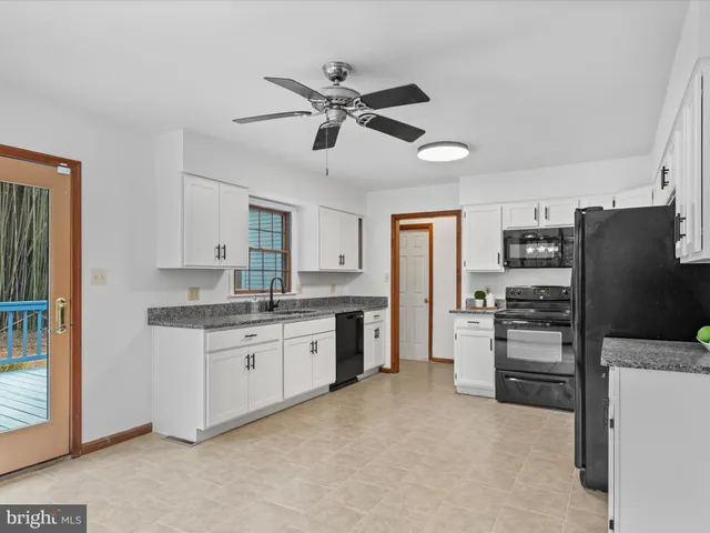 a kitchen with stainless steel appliances a refrigerator sink and stove