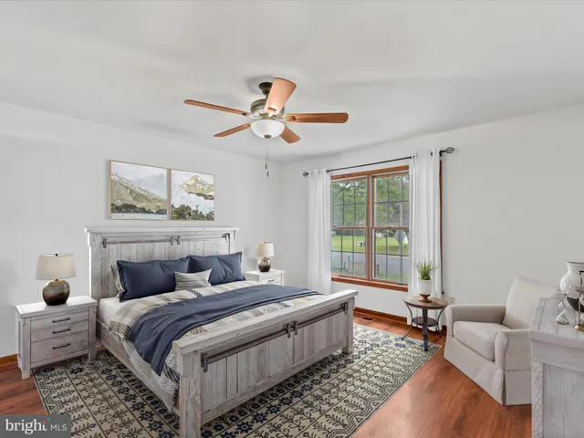 a bedroom with furniture and a large window