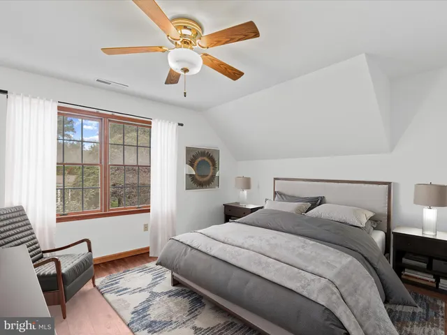 a bedroom with a large bed and a window