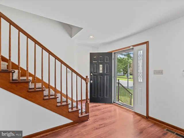 a view of an entryway with wooden floor