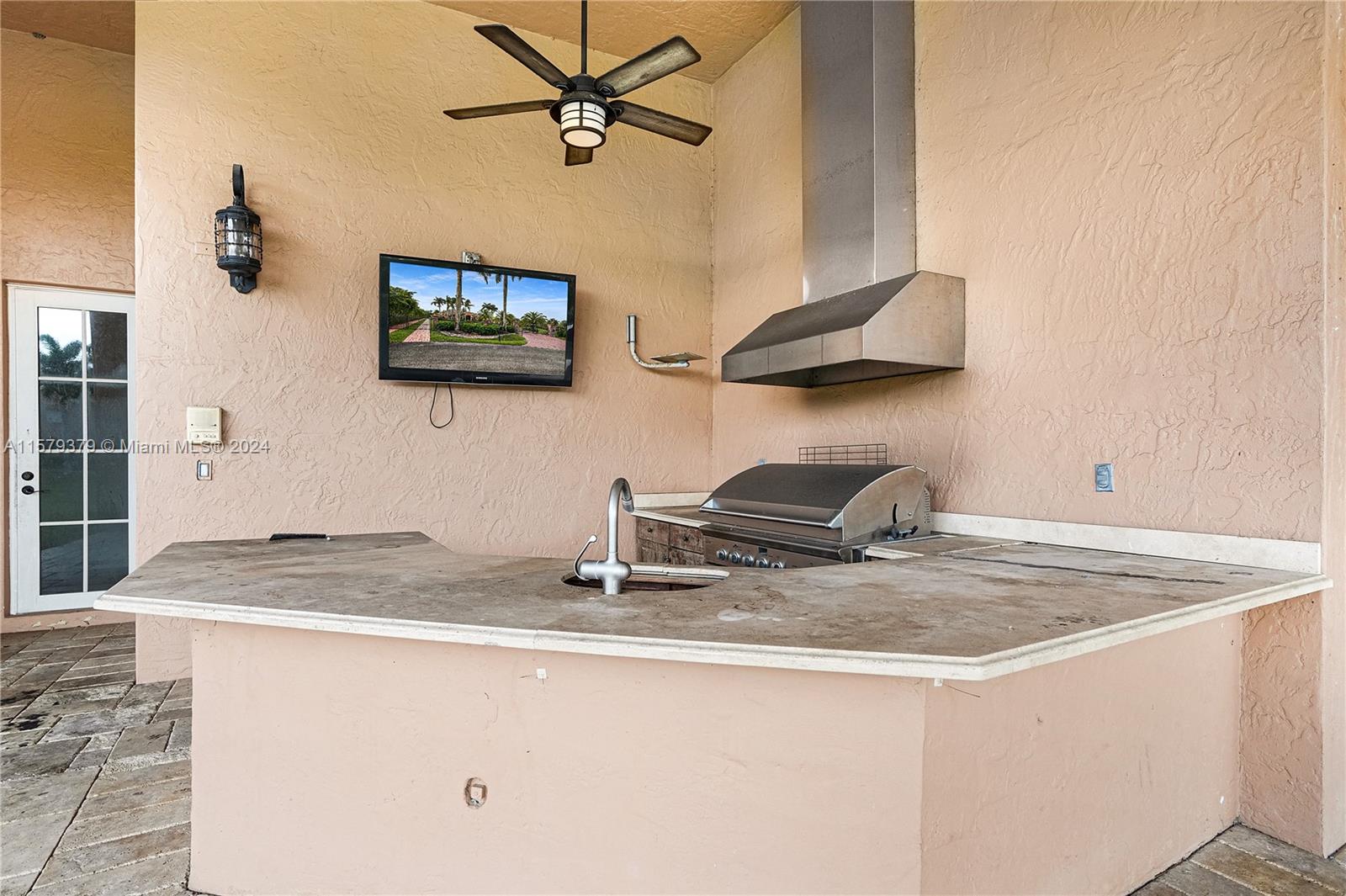 6225 Stallion Way Southwest Ranches, FL 33330 - Photo 43 of 56 a kitchen with a sink a stove and a granite top