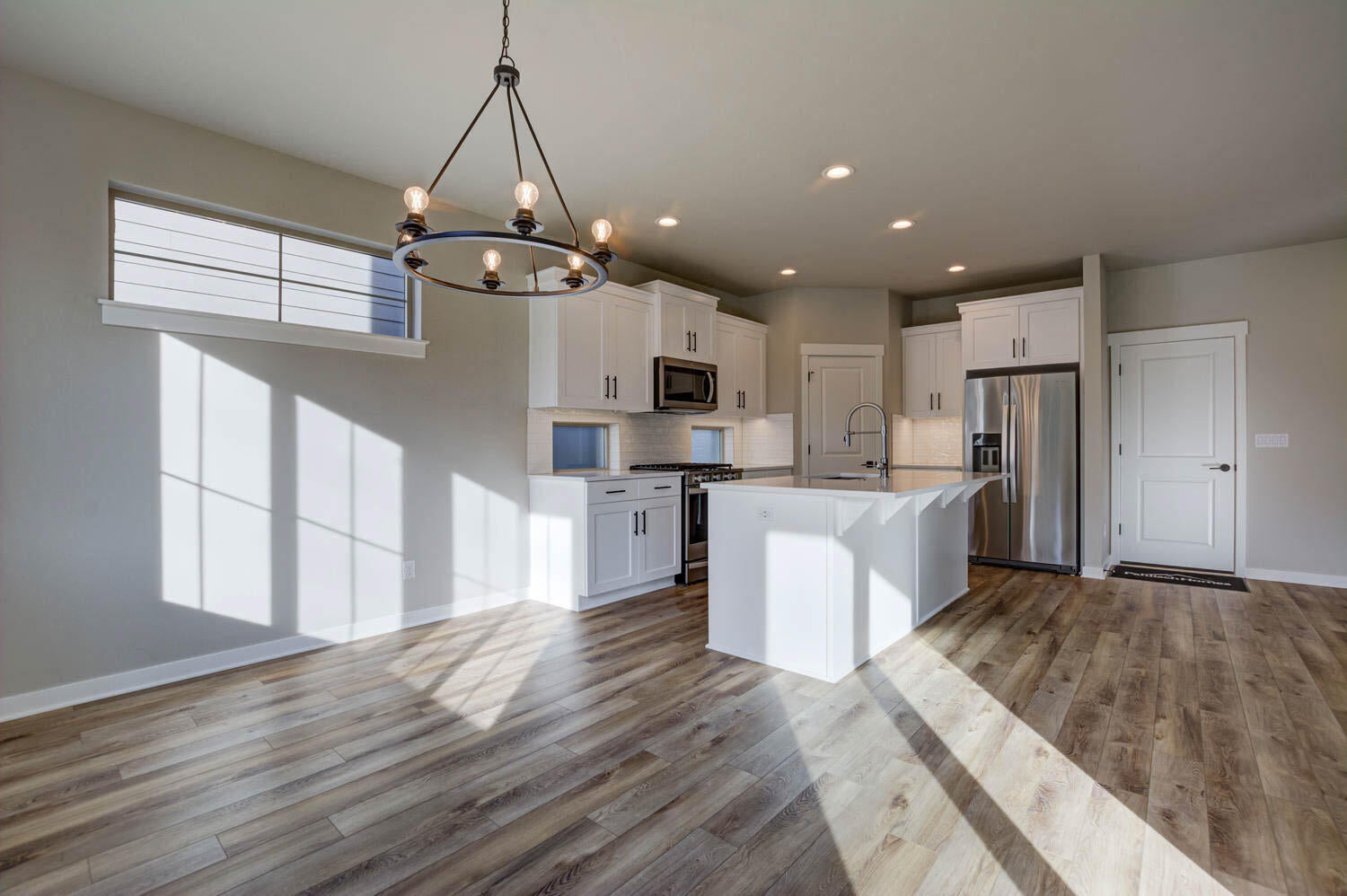 4652 Southwest 36th Street Redmond, OR 97756 - Photo 15 of 36 Kitchen and dining area. Greatroom. Example photo only. Some upgrades may be present. Specs and finishes vary. Refrigerator is not included.