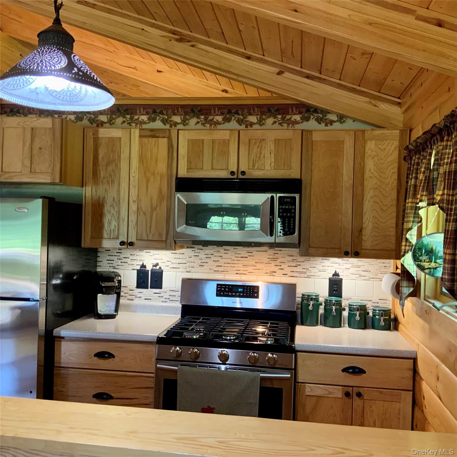 66 Milton Smith Road Long Eddy, NY 12760 - Photo 9 of 25 Bright kitchen with stainless steel appliances and rustic wood finishes throughout.